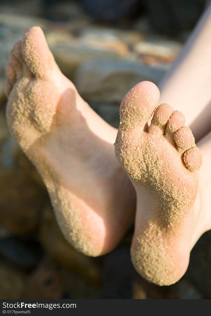 Legs of woman in a sand