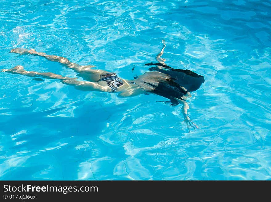 Woman underwater in swimming pool. Woman underwater in swimming pool