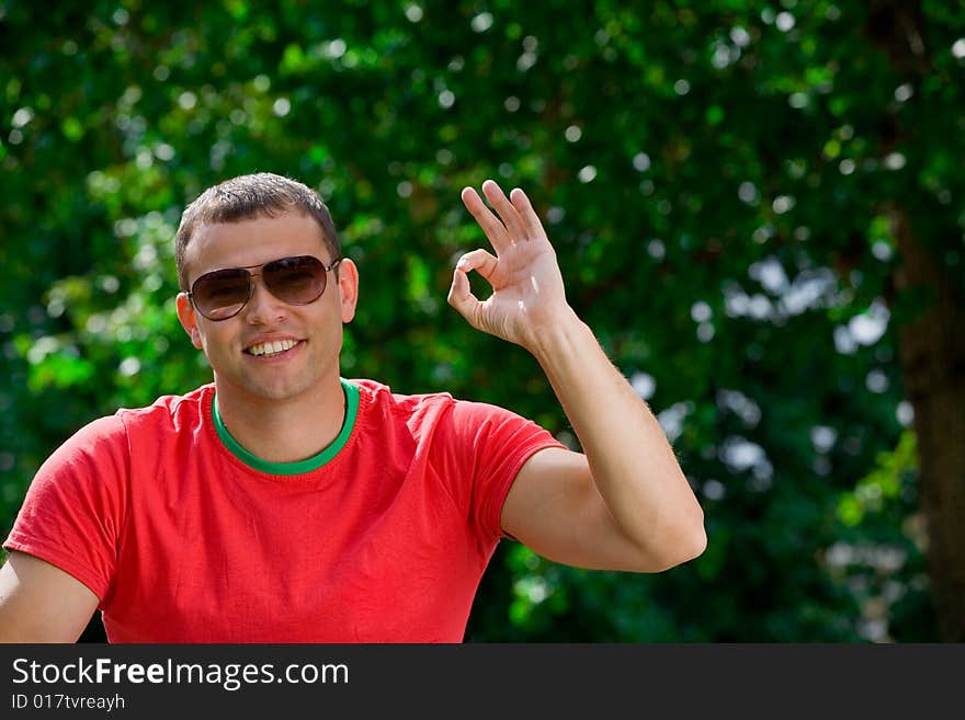 Young smiling man giving OK gesture. Young smiling man giving OK gesture