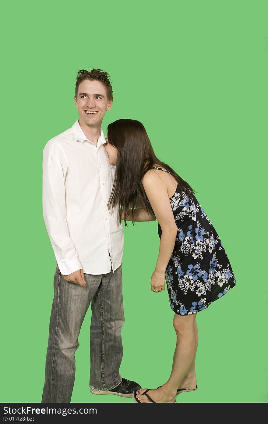 Happy couple standing together over green screen