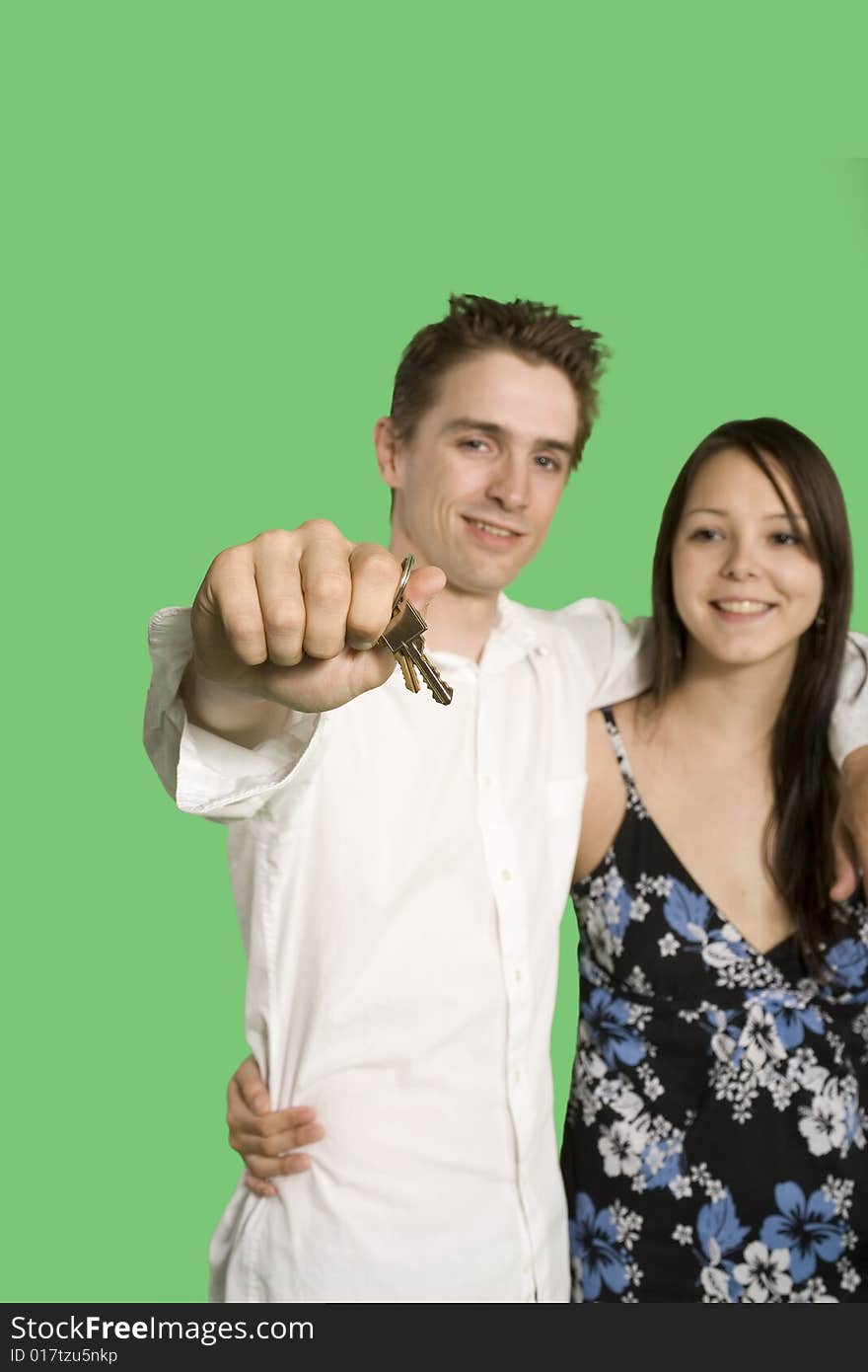 Couple showing house key over green screen. Couple showing house key over green screen