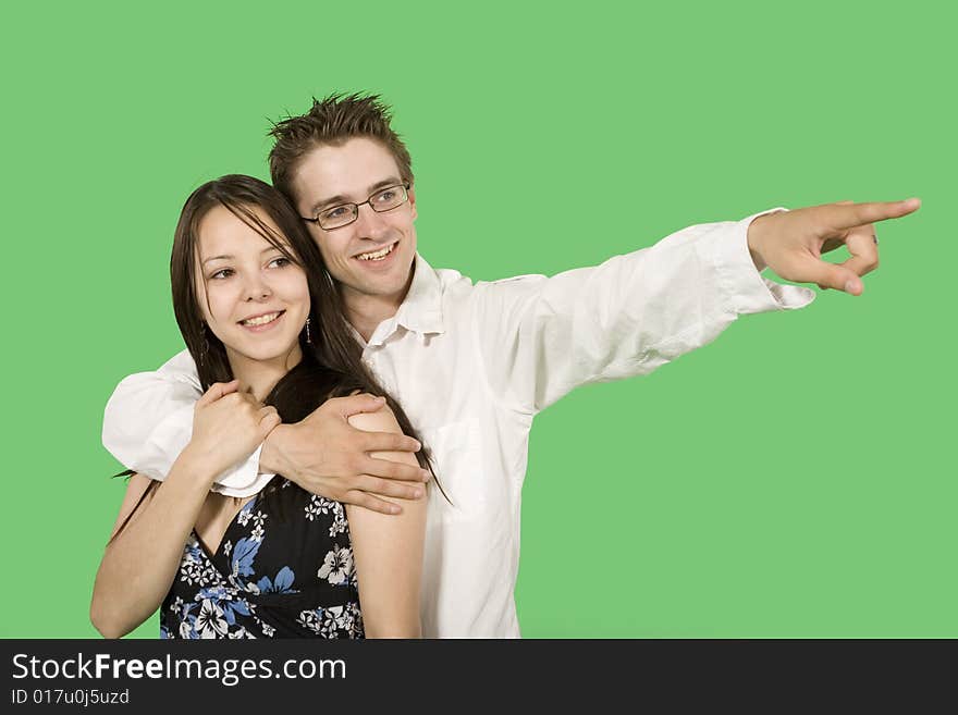 Couple looking at imaginary point over green screen. Couple looking at imaginary point over green screen