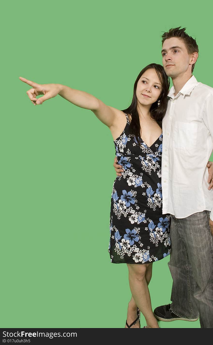 Couple looking at imaginary point over green screen. Couple looking at imaginary point over green screen