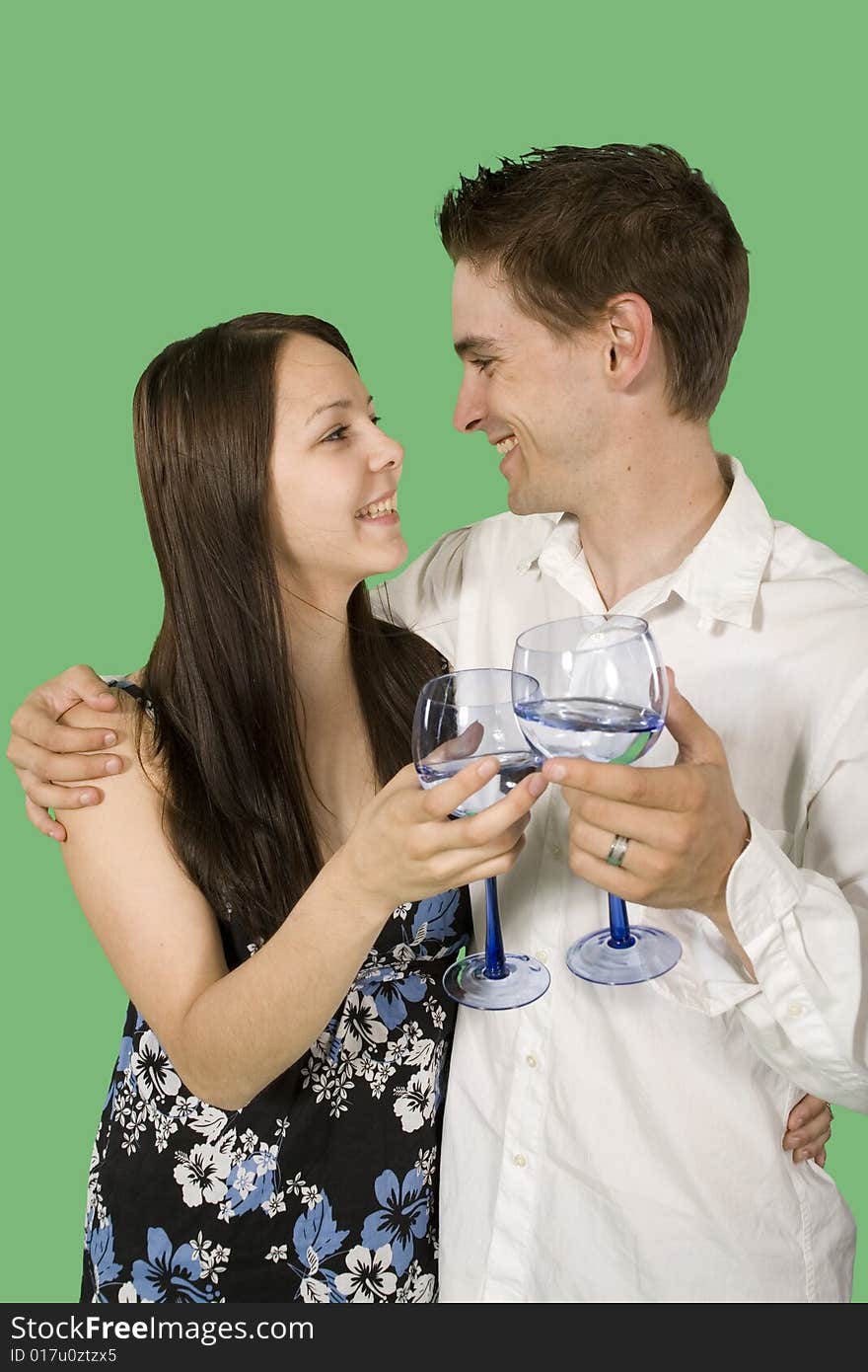 Couple drinking and smiling over green screen