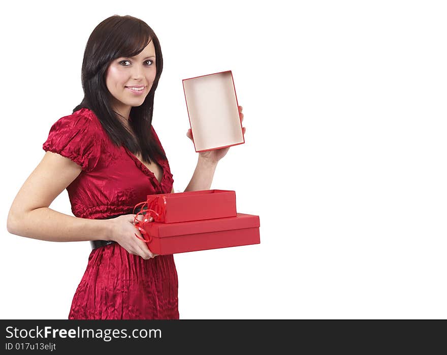 Portrait of a beautiful young brunette woman opening gift boxes at a celebration. Isolated on white background. Portrait of a beautiful young brunette woman opening gift boxes at a celebration. Isolated on white background