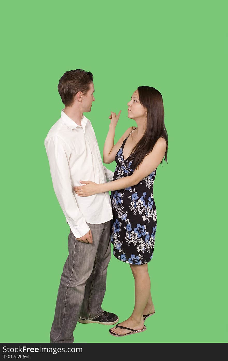 Happy couple standing together over green screen