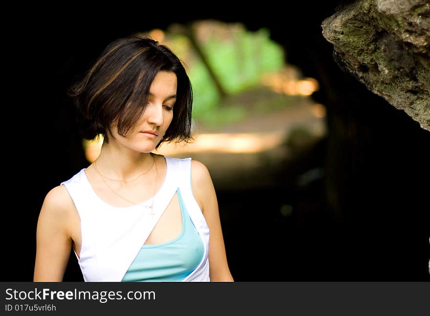 Portrait of pretty unhappy woman in the cave