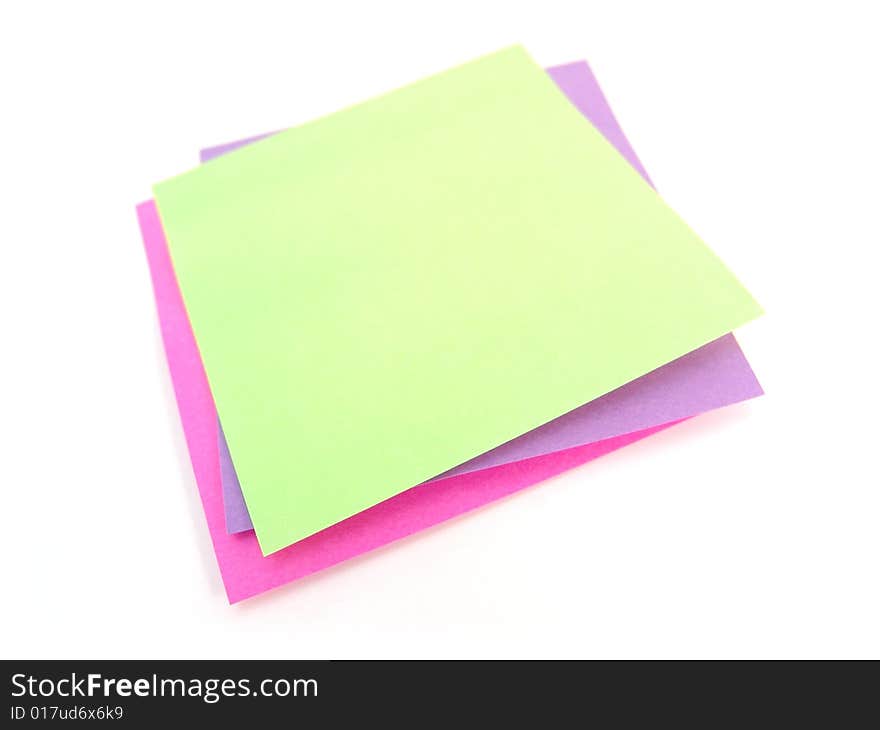 Green, pink and purple sticky notes over white background