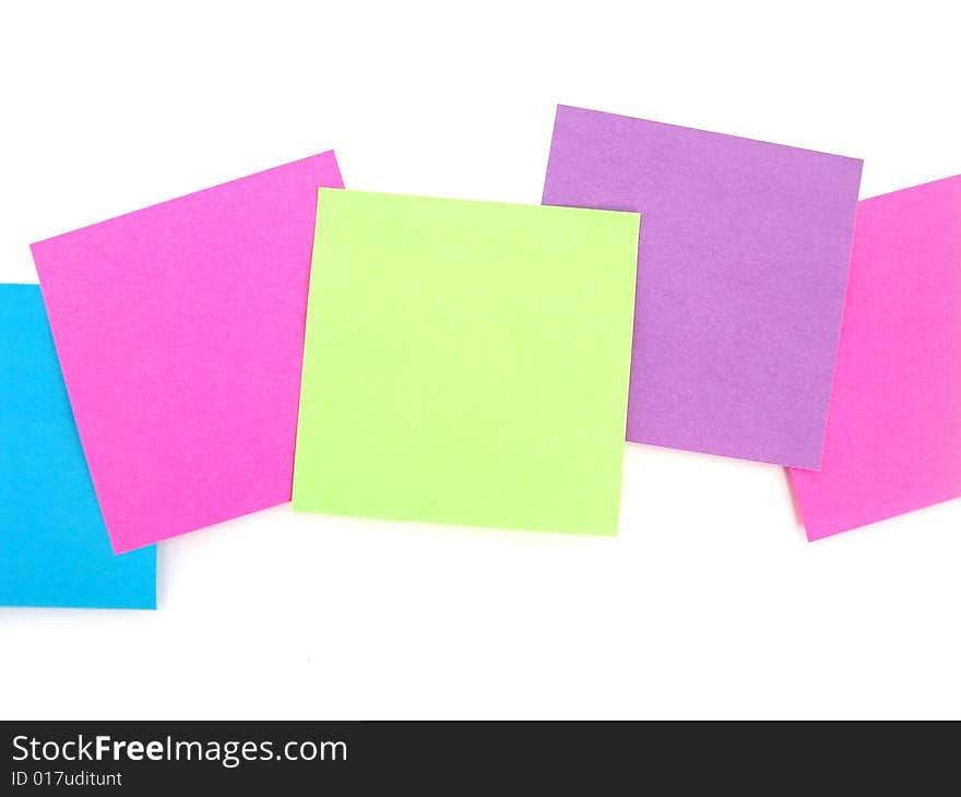 Green, pink and purple sticky notes over white background