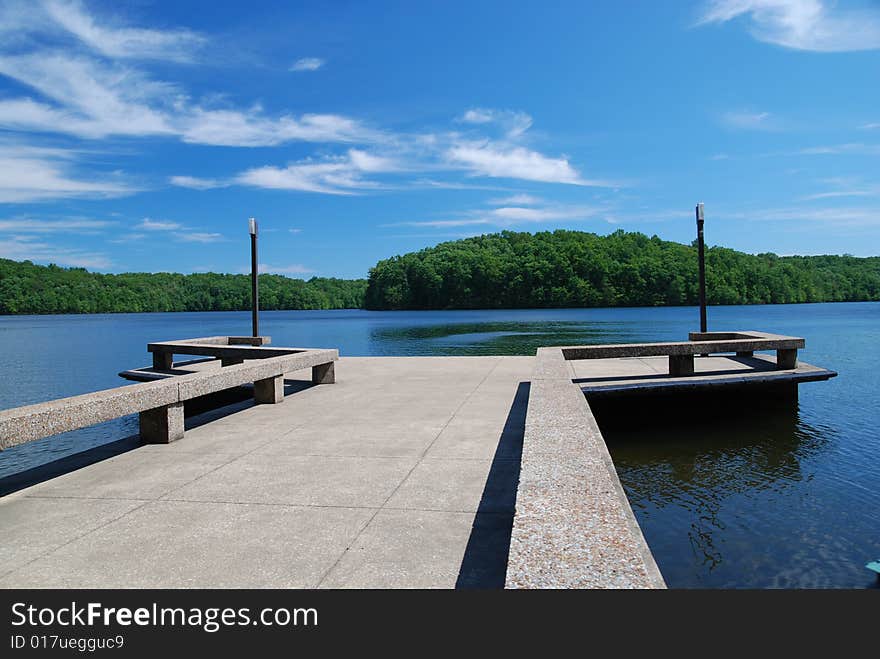 Concrete dock in calm blue lake