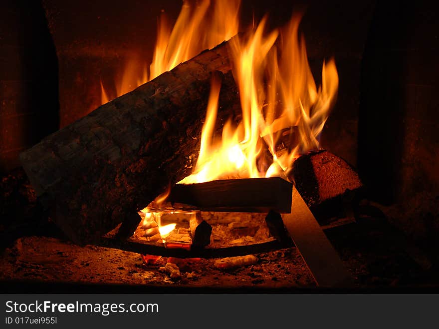 Burning wood with beautiful flames in a fireplace.