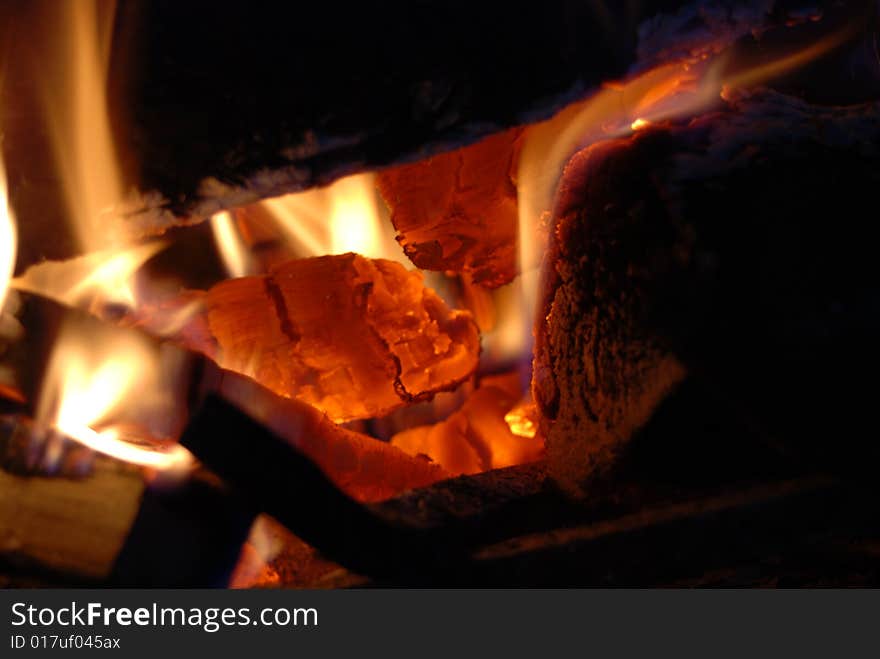 Burning wood with beautiful flames in a fireplace.