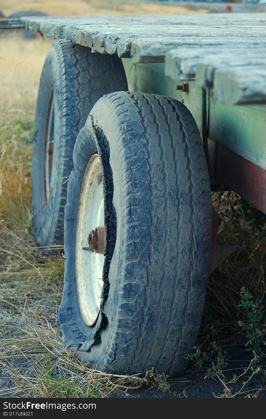 Old broken tractor hanger lying in a field. Old broken tractor hanger lying in a field