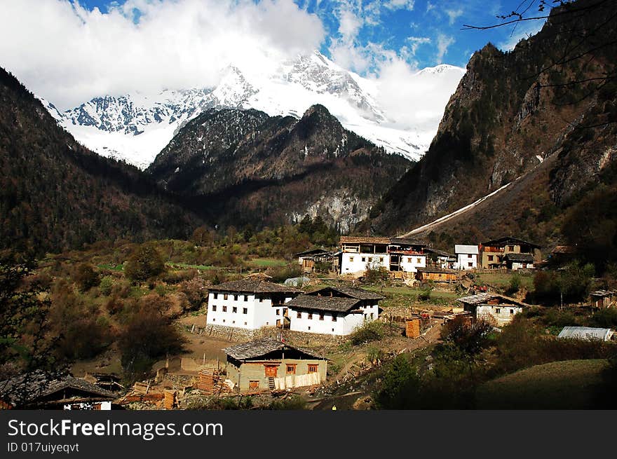 Distant snow mountains and a village named Yubeng in Shangrila,Yunnan,China