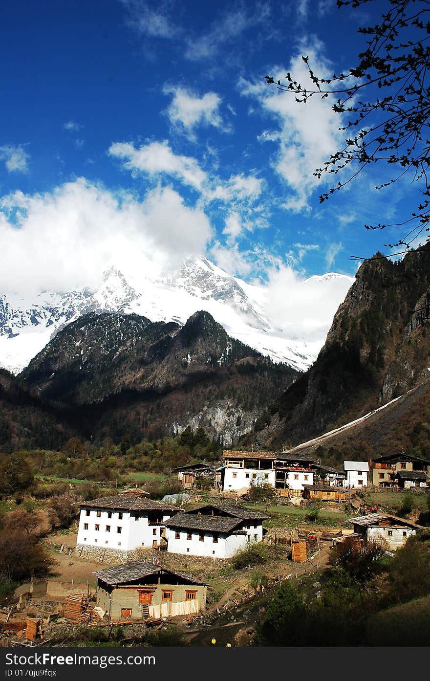 Distant snow mountains and a village named Yubeng in Shangrila,Yunnan,China