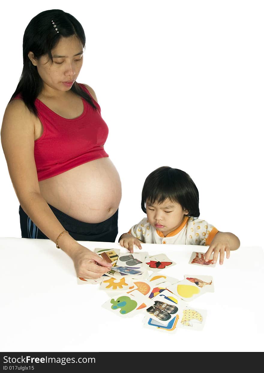 Pregnant woman teaching daughter study with white background.