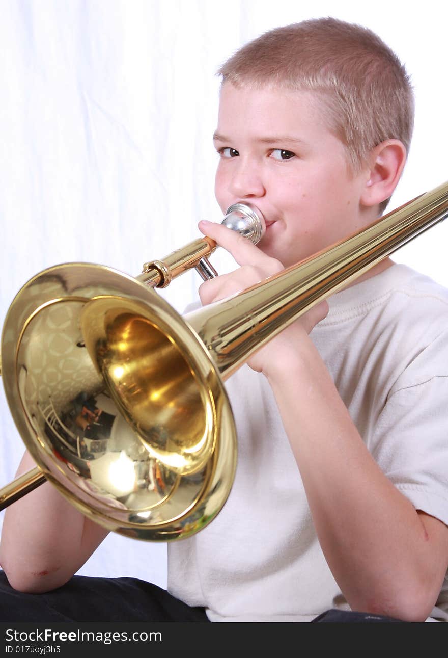 Young boy playing the trombone. Young boy playing the trombone