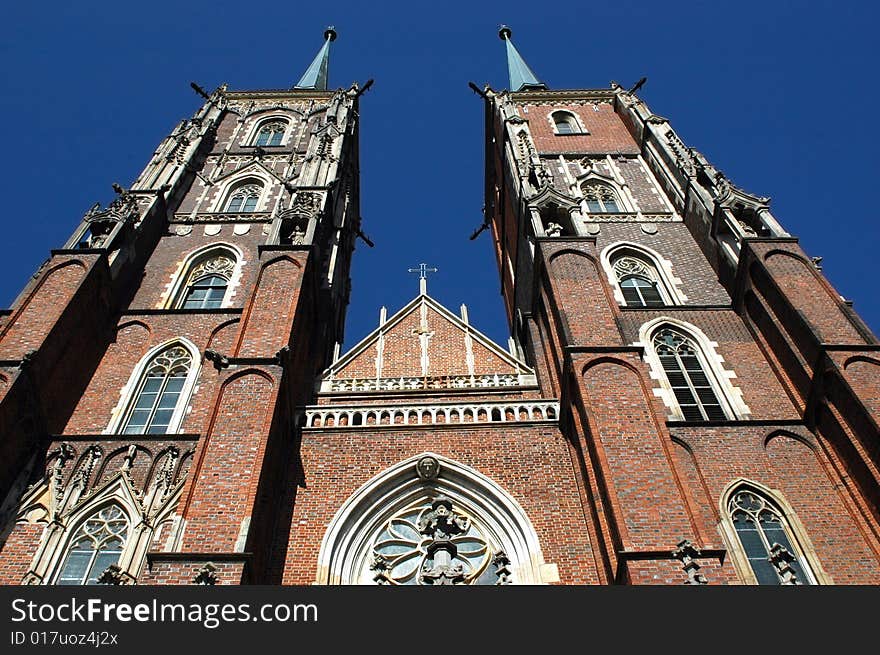 Poland, Wroclaw - old town with most famous and biggest cathedral. Front side with two amazing towers in gothic style. Poland, Wroclaw - old town with most famous and biggest cathedral. Front side with two amazing towers in gothic style.