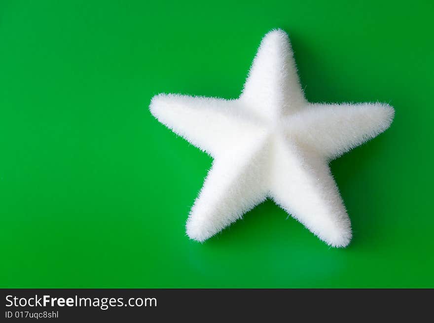 Christmas star with a white star on green background