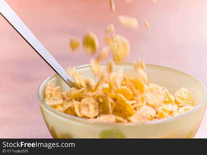 Corn flakes with milk and spoon