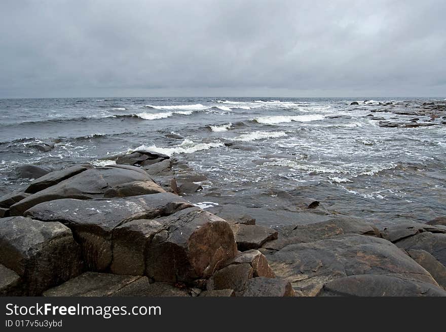 White sea 	storm landscape with stones