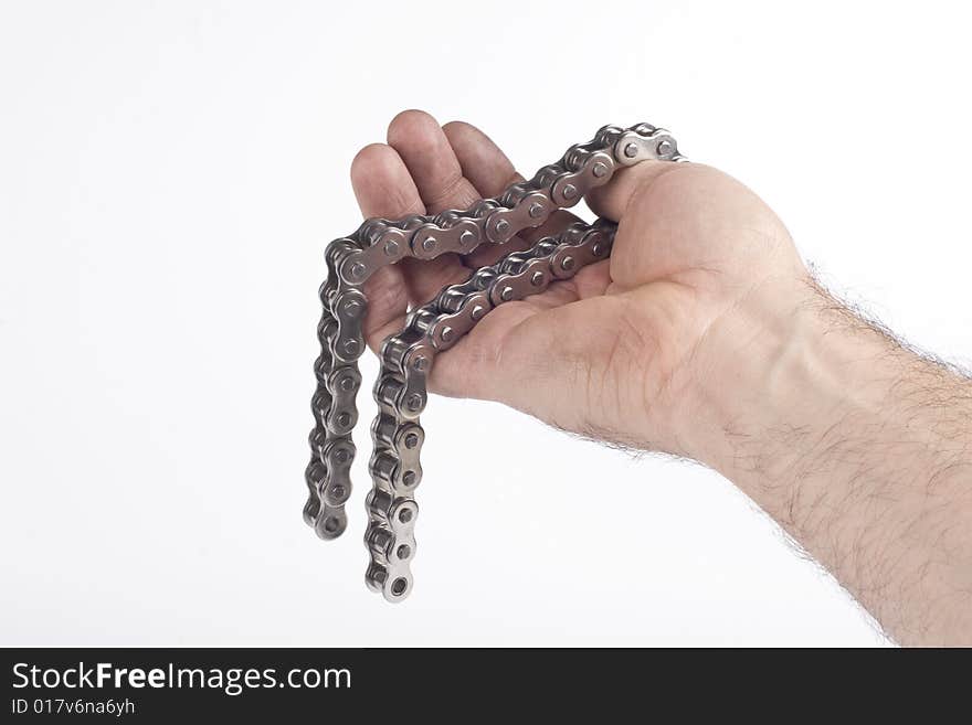 Hand with metal link chain on a white