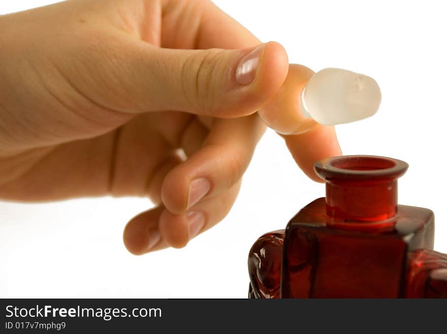 Red perfume glass in hands. Red perfume glass in hands