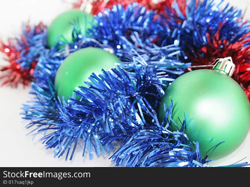 Green, red, dark blue ornaments on a New Year tree. Green, red, dark blue ornaments on a New Year tree