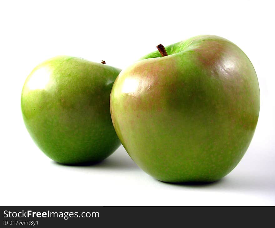 A pair of Granny Smith apples on a white background. A pair of Granny Smith apples on a white background