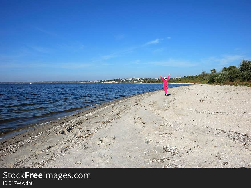 Running child on river shore