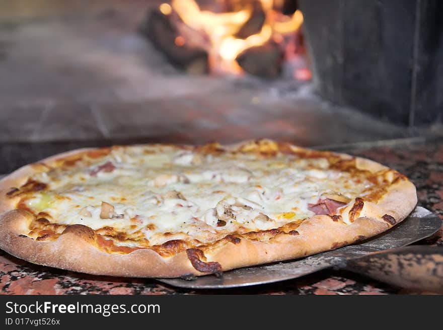 Fresh Pizza, oven or stoven at background. Fresh Pizza, oven or stoven at background