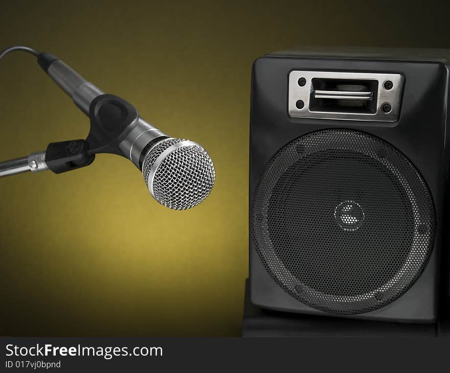 Professional microphone and speaker with a diffuse yellow background. Professional microphone and speaker with a diffuse yellow background.