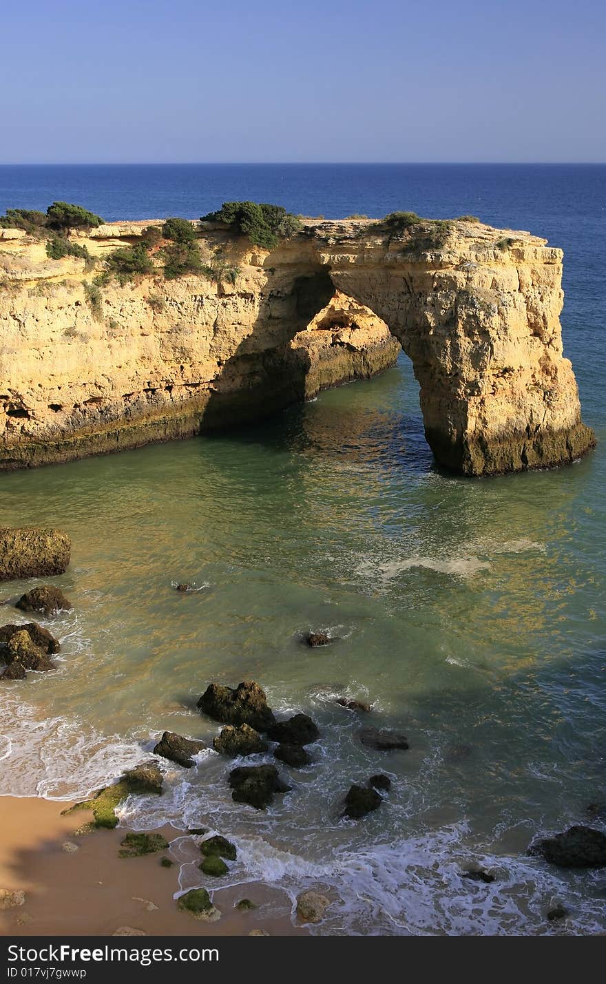 Coastline with a natural arch - Algarve, Portugal.