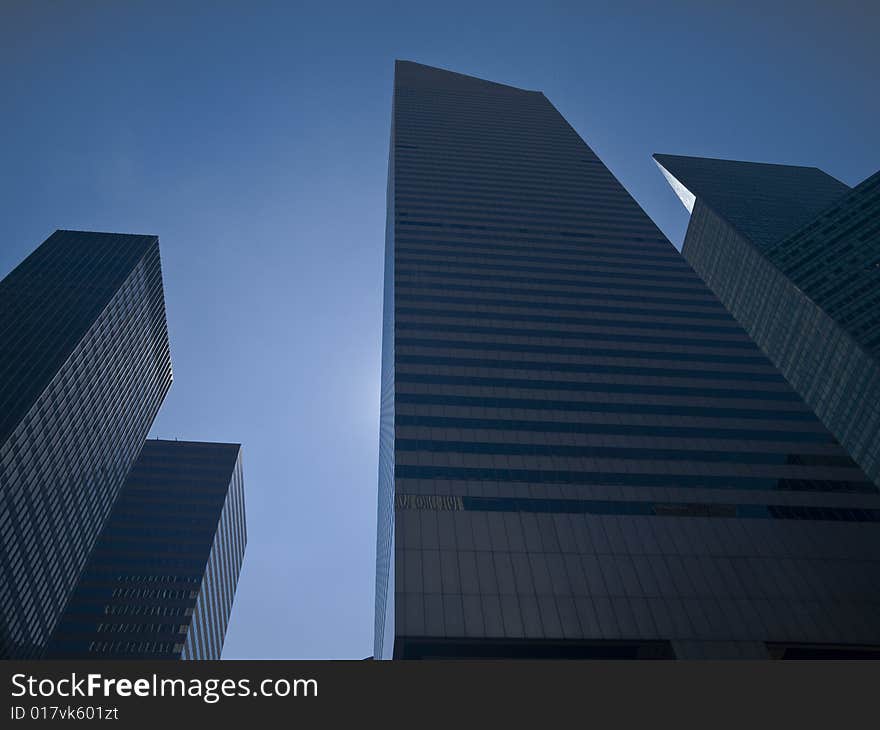 High modern skyscrapers on a background of a blue sky. High modern skyscrapers on a background of a blue sky.