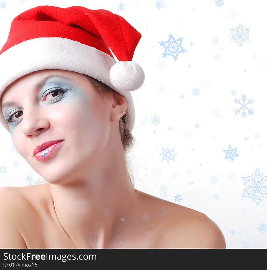 Young beautiful woman in a santa hat with winter make-up. Young beautiful woman in a santa hat with winter make-up