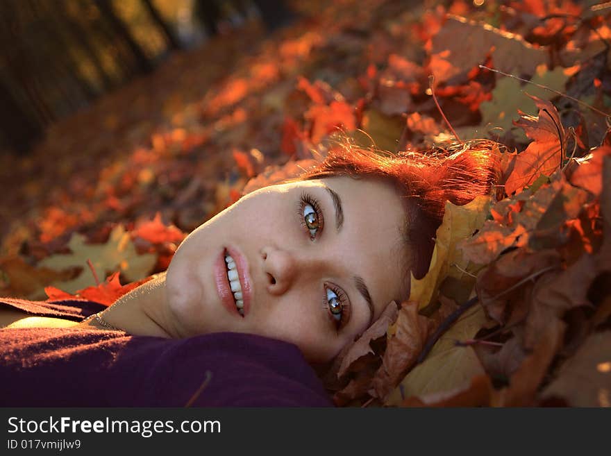 Girl laying in autumn leaves. Girl laying in autumn leaves