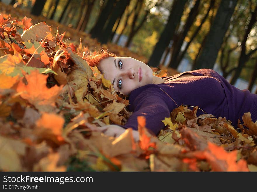 Girl laying in autumn leaves. Girl laying in autumn leaves