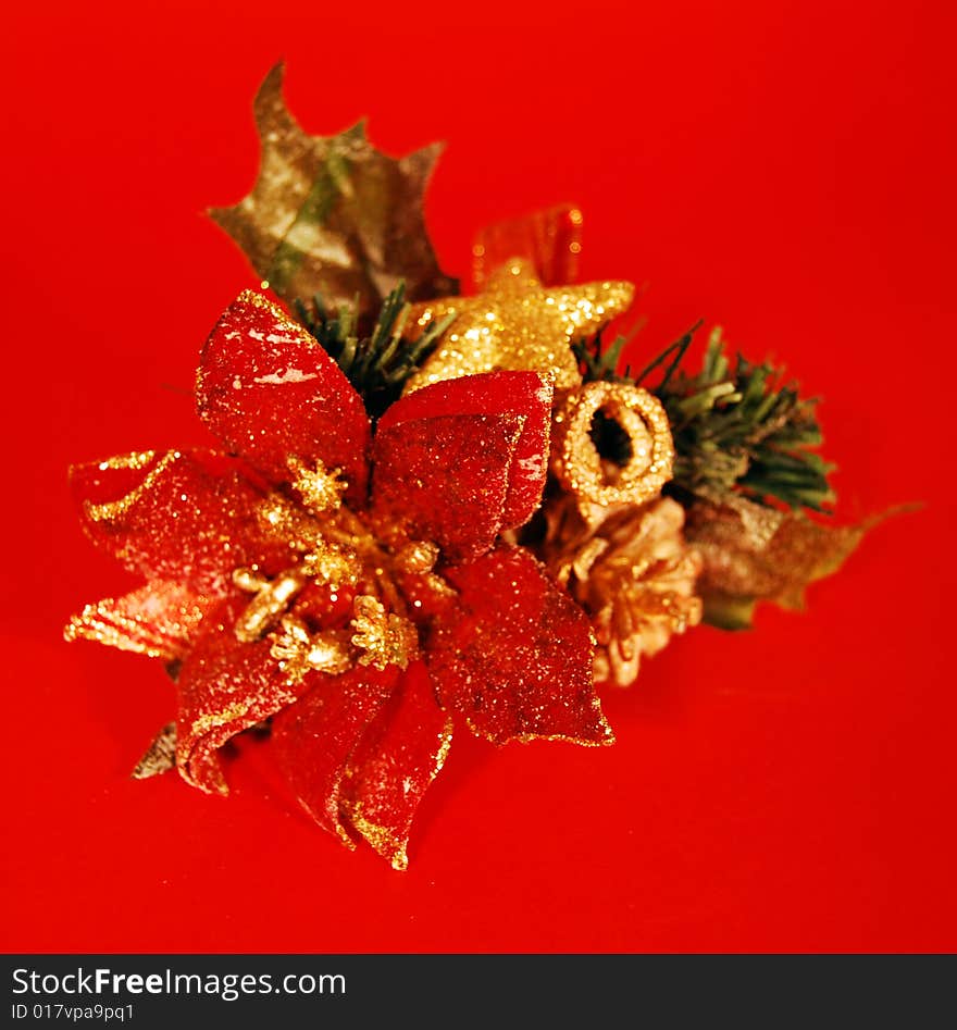 A christmas decoration with a red flower and a golden star