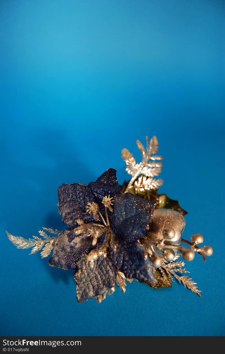 A christmas decoration with a blue flower