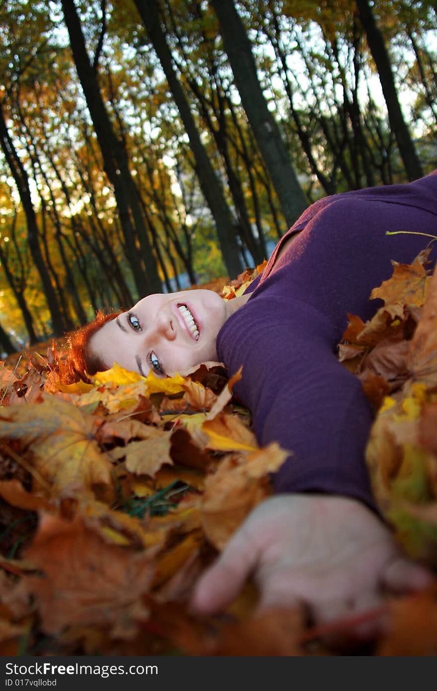 Girl laying in autumn leaves. Girl laying in autumn leaves