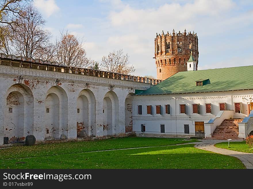 Courtyard of an ancient monastery with a fortification and a tower. Courtyard of an ancient monastery with a fortification and a tower