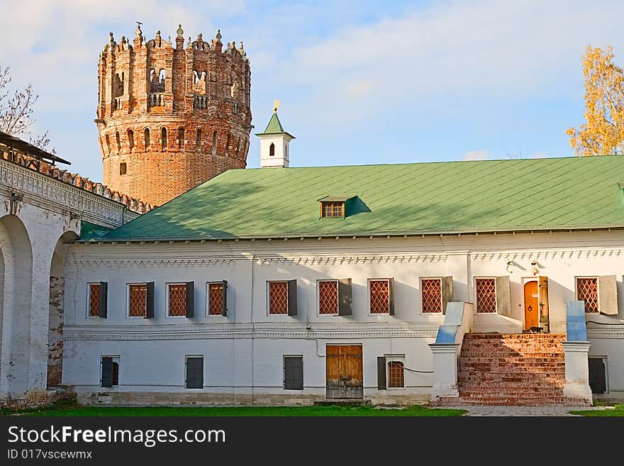 Courtyard of the ancient monastery walls house with a green roof and tower. Courtyard of the ancient monastery walls house with a green roof and tower