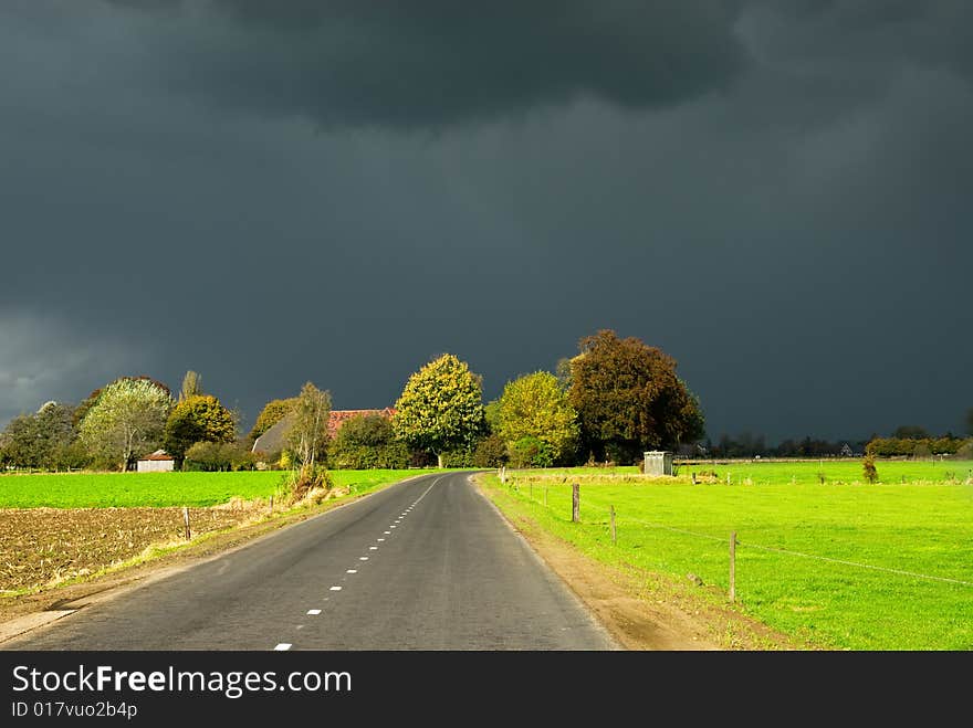 A road towards a dark autumn sky in the Netherlands