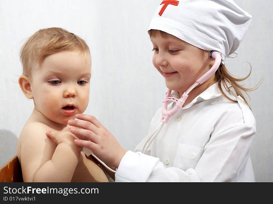 Snapshot on the theme medicine. Children playing in doctor. Snapshot on the theme medicine. Children playing in doctor