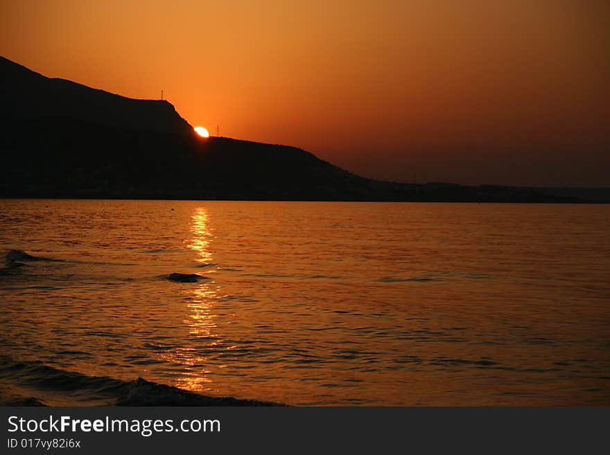 A photo of a beach and a mountain on the background. A photo of a beach and a mountain on the background