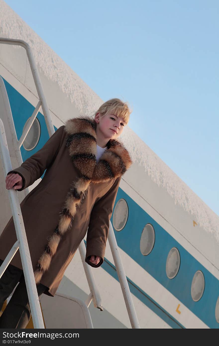 Beautiful flight attendant standing on the airstairs. Beautiful flight attendant standing on the airstairs