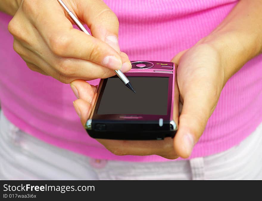 Hands with communicator isolated over pink background