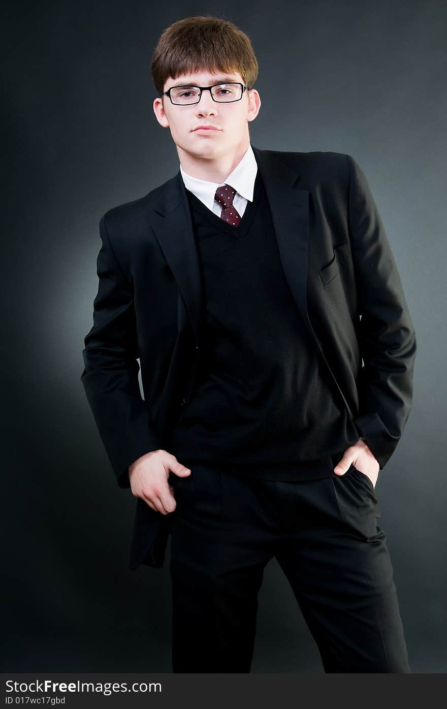 Young handsome businessman in black suit