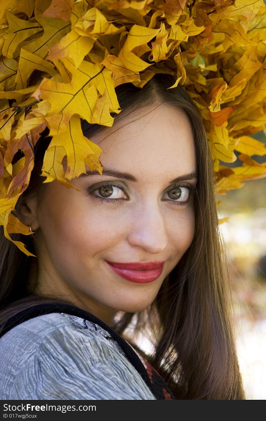 A young beautiful woman wearing a leaf wreath on her head. A young beautiful woman wearing a leaf wreath on her head.