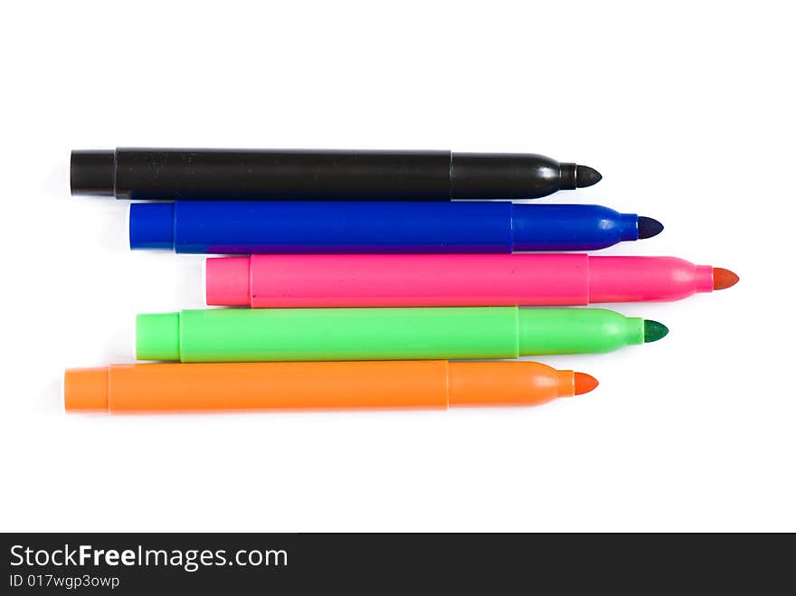 Varicoloured markers on the white isolated background